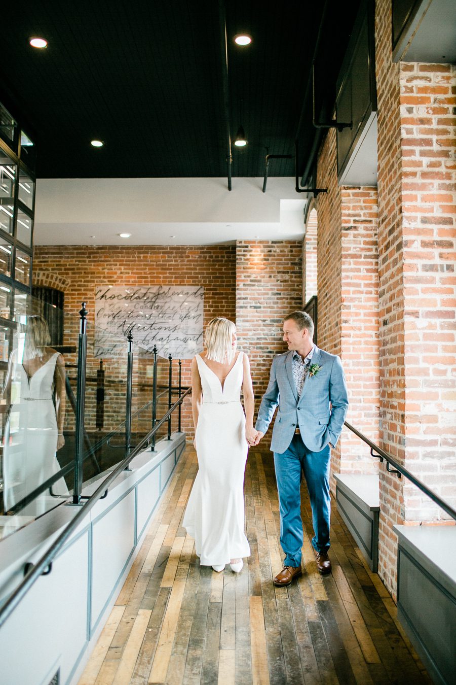 modern greenhouse wedding photos, carly mccray photography, lake geneva wedding photographer, madison wedding photographers, modern greenery wedding, modern wisconsin greenhouse wedding, modern greenery wedding, sleek wedding dress, greenery boutonnieres, black taper candles, green florals, modern greens