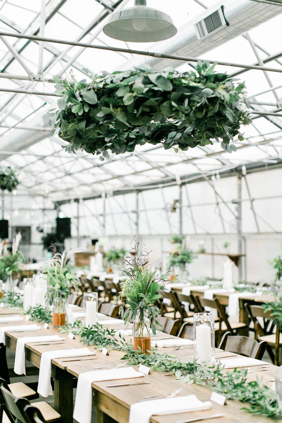 modern greenhouse wedding photos, carly mccray photography, lake geneva wedding photographer, madison wedding photographers, modern greenery wedding, modern wisconsin greenhouse wedding, modern greenery wedding, sleek wedding dress, greenery boutonnieres, black taper candles, green florals, modern greens