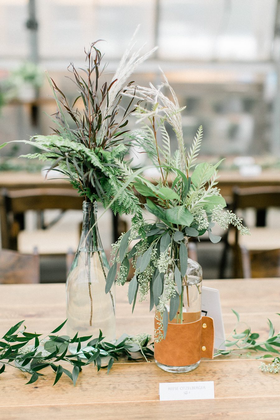 modern greenhouse wedding photos, carly mccray photography, lake geneva wedding photographer, madison wedding photographers, modern greenery wedding, modern wisconsin greenhouse wedding, modern greenery wedding, sleek wedding dress, greenery boutonnieres, black taper candles, green florals, modern greens