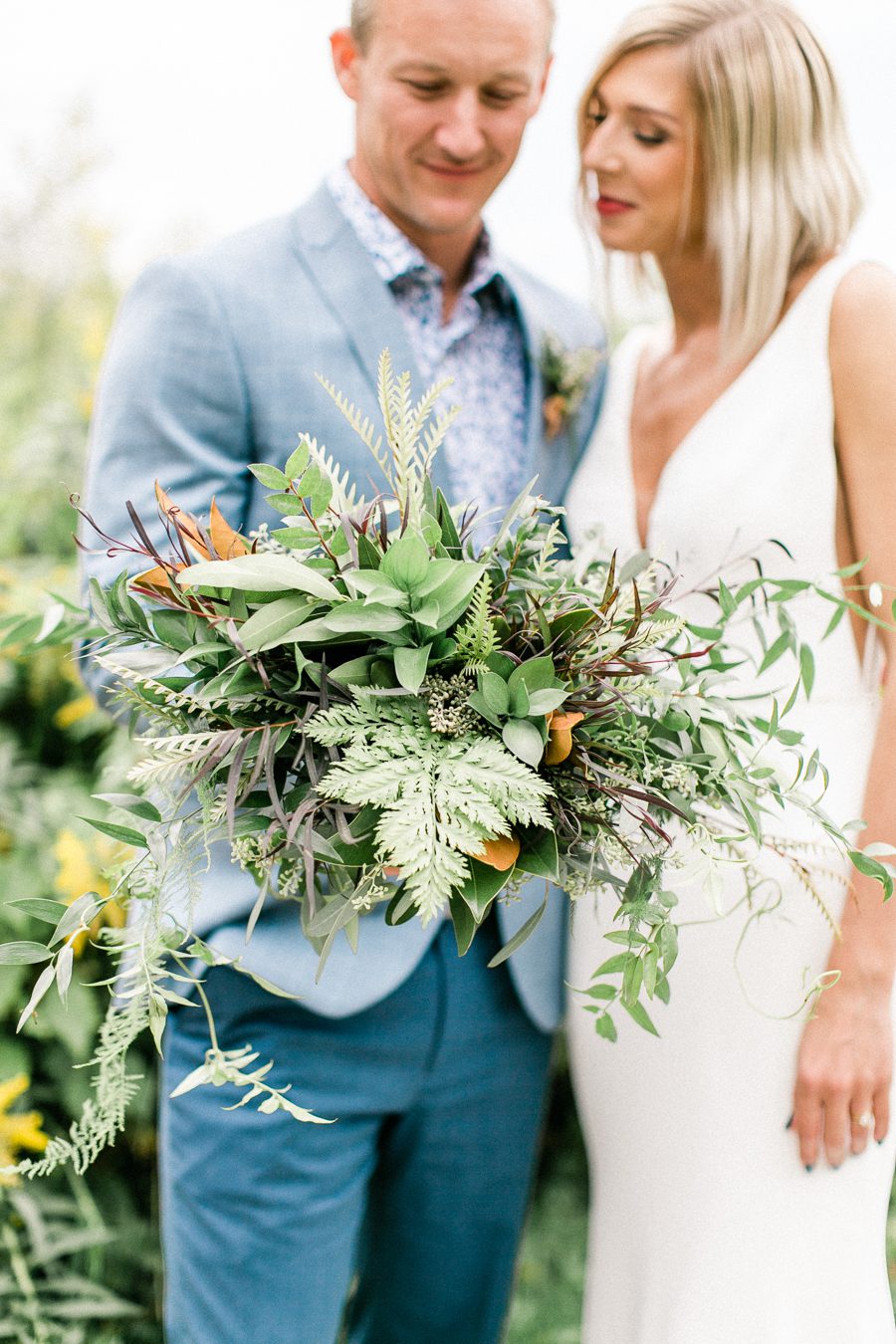 modern greenhouse wedding photos, carly mccray photography, lake geneva wedding photographer, madison wedding photographers, modern greenery wedding, modern wisconsin greenhouse wedding, modern greenery wedding, sleek wedding dress, greenery boutonnieres, black taper candles, green florals, modern greens