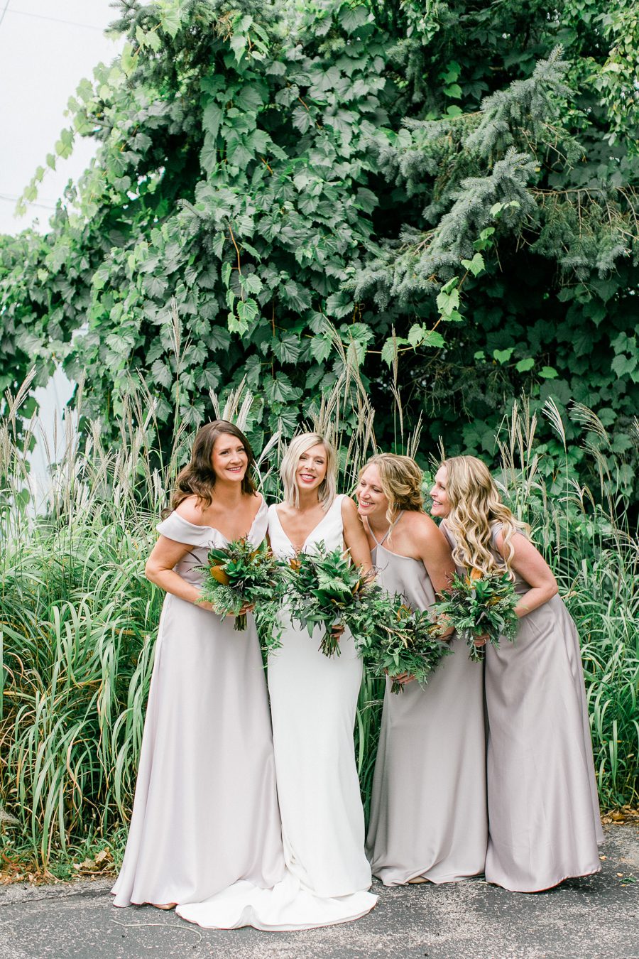 modern greenhouse wedding photos, carly mccray photography, lake geneva wedding photographer, madison wedding photographers, modern greenery wedding, modern wisconsin greenhouse wedding, modern greenery wedding, sleek wedding dress, greenery boutonnieres, black taper candles, green florals, modern greens
