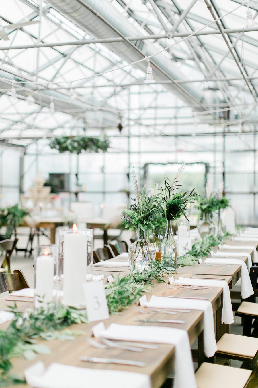 modern greenhouse wedding photos, carly mccray photography, lake geneva wedding photographer, madison wedding photographers, modern greenery wedding, modern wisconsin greenhouse wedding, modern greenery wedding, sleek wedding dress, greenery boutonnieres, black taper candles, green florals, modern greens