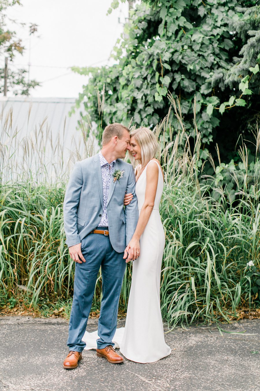 modern greenhouse wedding photos, carly mccray photography, lake geneva wedding photographer, madison wedding photographers, modern greenery wedding, modern wisconsin greenhouse wedding, modern greenery wedding, sleek wedding dress, greenery boutonnieres, black taper candles, green florals, modern greens