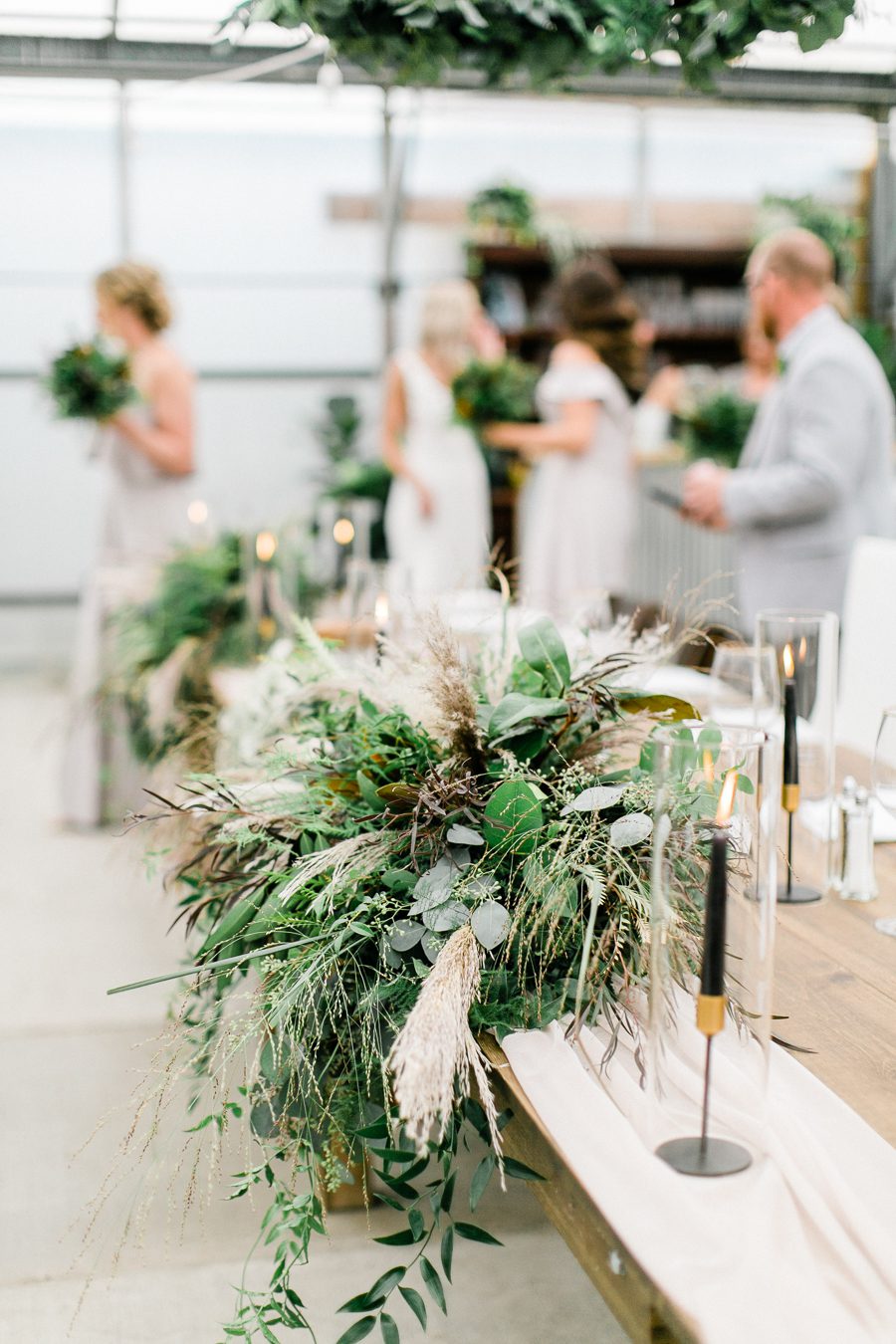 modern greenhouse wedding photos, carly mccray photography, lake geneva wedding photographer, madison wedding photographers, modern greenery wedding, modern wisconsin greenhouse wedding, modern greenery wedding, sleek wedding dress, greenery boutonnieres, black taper candles, green florals, modern greens