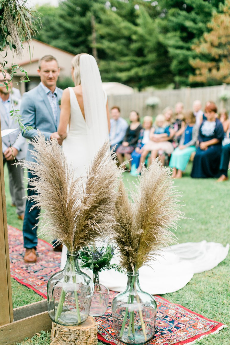 modern greenhouse wedding photos, carly mccray photography, lake geneva wedding photographer, madison wedding photographers, modern greenery wedding, modern wisconsin greenhouse wedding, modern greenery wedding, sleek wedding dress, greenery boutonnieres, black taper candles, green florals, modern greens