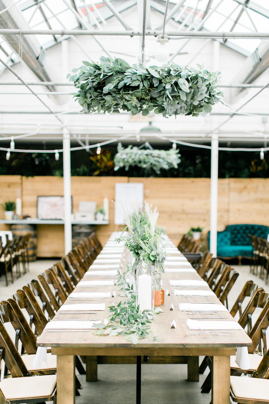 modern greenhouse wedding photos, carly mccray photography, lake geneva wedding photographer, madison wedding photographers, modern greenery wedding, modern wisconsin greenhouse wedding, modern greenery wedding, sleek wedding dress, greenery boutonnieres, black taper candles, green florals, modern greens